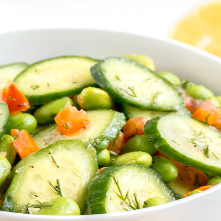 A bowl of easy cucumber salad with tomatoes.