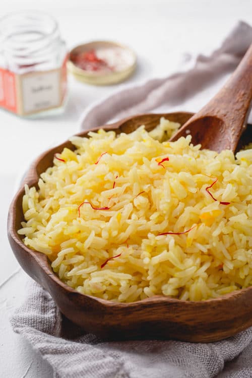 Saffron rice - an easy way to upgrade regular rice side dish. Just a pinch of saffron magically transforms plain rice into beautiful golden colored rice.