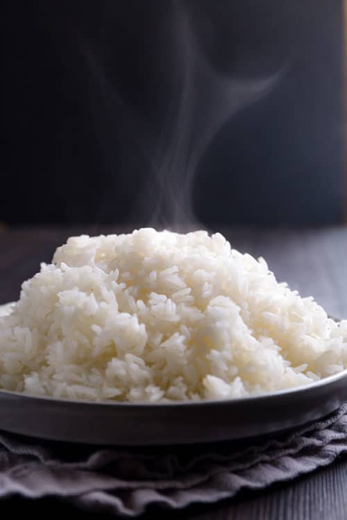 You don’t need a rice cooker to make a perfectly fluffy white rice! Sharing my foolproof method to cook simple, yet deliciously fluffy white rice on stovetop and answering all your questions on how to cook rice on stovetop. #rice #whiterice #jasminerice #howtocookrice