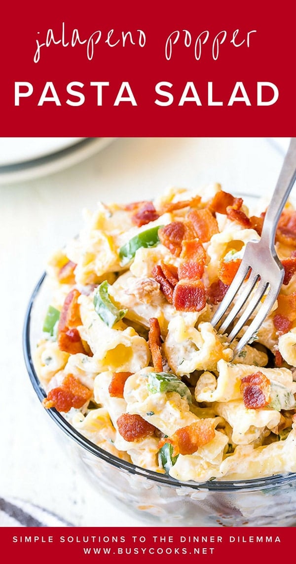 A fork sticking out of a bowl of jalapeño popper salad and a banner that reads "jalapeno popper pasta salad". 