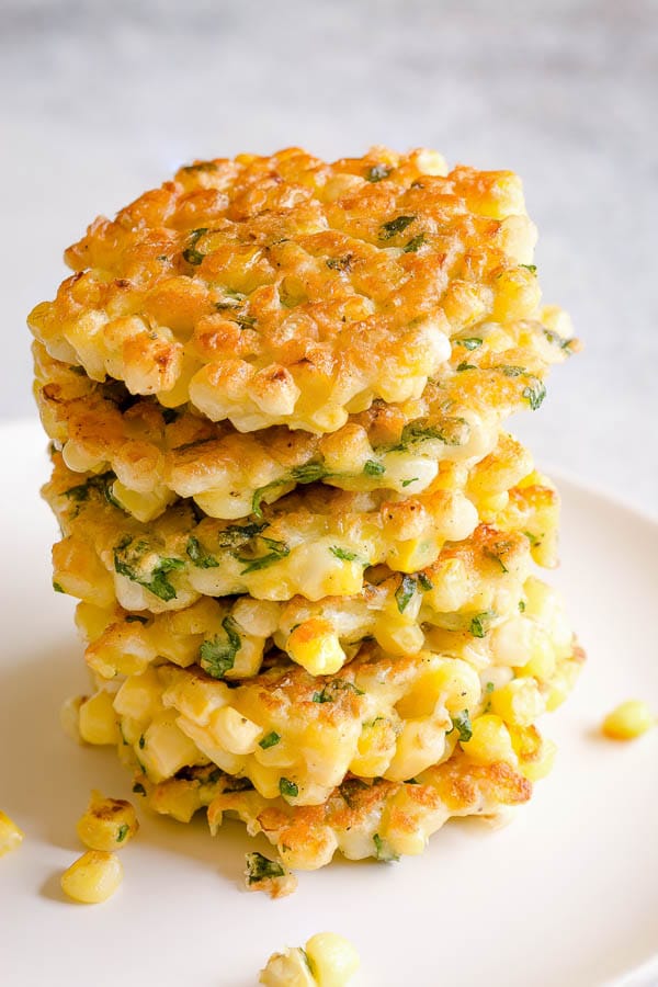 This easy corn fritters recipe makes delicately light and crisp fritters, studded with plenty of fresh sweet corns. All you need is simple ingredients and ONE bowl. #cornfritters