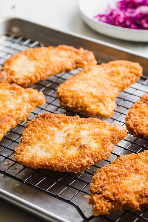 You'll be surprised how quick and easy to make these kid-approved weeknight meal. The secret is in super thin pork chops, it literally takes couple minutes to pan-fry these breaded pork chops on each side. And panko, Japanese breadcrumbs, creates that satisfying light and crispy crust. 