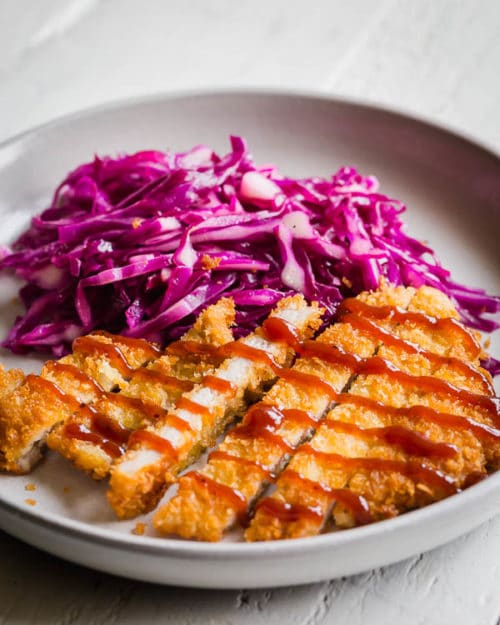 Simple pork cutlets with satisfying light and crispy crust and juicy tender meat. It pairs beautifully with tangy quick red cabbage slaw. Perfect weeknight meal in under 30 minutes!