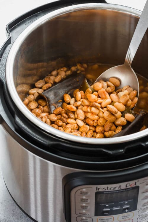 Easy guide on how to cook pinto beans in an Instant Pot in less than an hour without soaking the beans. The beans come out flavorful and creamy. #pintobeans #drybeans #instantpotrecipe #busycooks