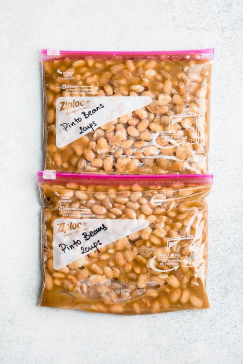 Learn how to cook dry pinto beans in a pressure cooker under 1 hour. Plus, storing tips for large batches of cooked beans. #pintobeans #drybeans #instantpotrecipe #busycooks