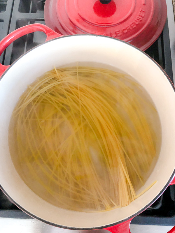 Spaghetti noodles boiling in a pot. 