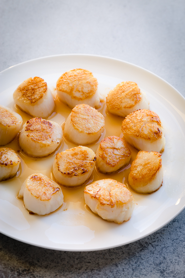Cooked scallops on a plate. 