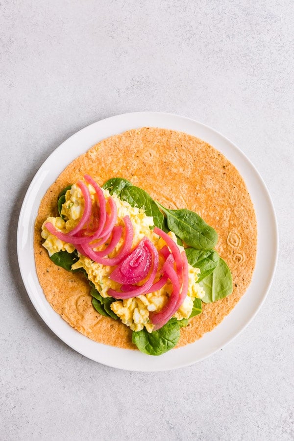 Pickled onions on an egg salad wrap. 