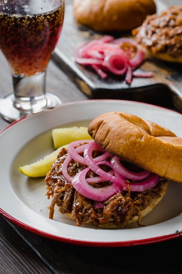 Pickled red onions on a pulled pork sandwich. 