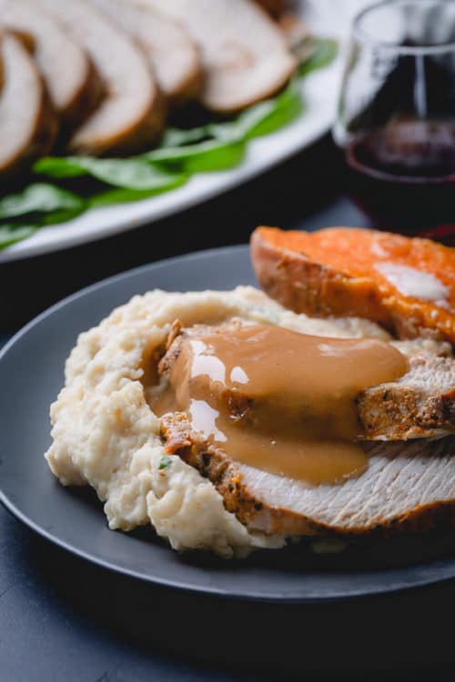 Instant Pot turkey breast, mashed potatoes, baked sweet potatoes, and gravy all in one pot! Yes, you can make an entire Thanksgiving dinner in an Instant Pot all at once! #thanksgiving #instantpotthanksgivingdinner #instantpotturkey
