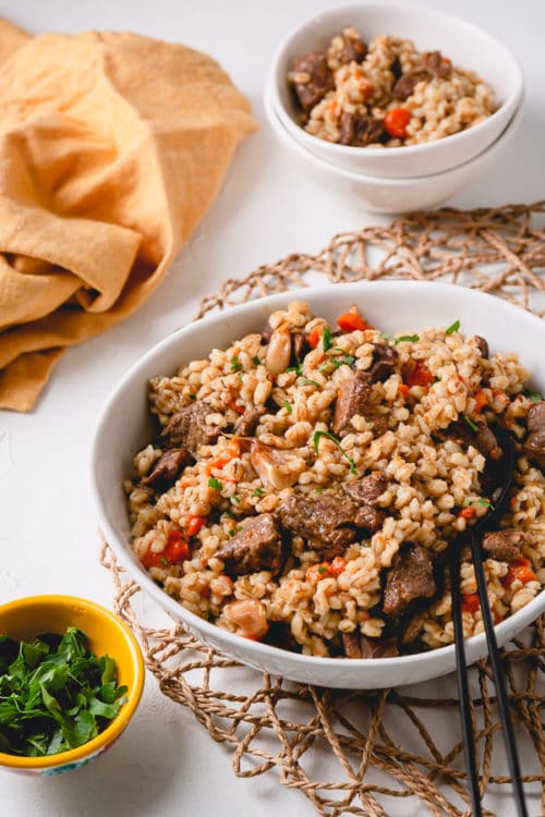 Beef and barley pilaf (beef plov) is a delicious and hearty dish cooked in Instant Pot in less than 1 hour! #InstantPotDinner #hulledbarley #barleypilaf