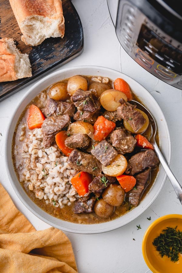 a bowl of beef stew with carrots