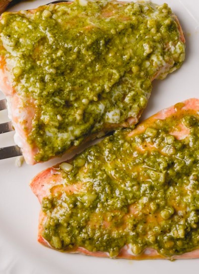 Tender soft baked salmon filet infused with herby pesto - perfect 30-minute dinner. #salmonrecipe
