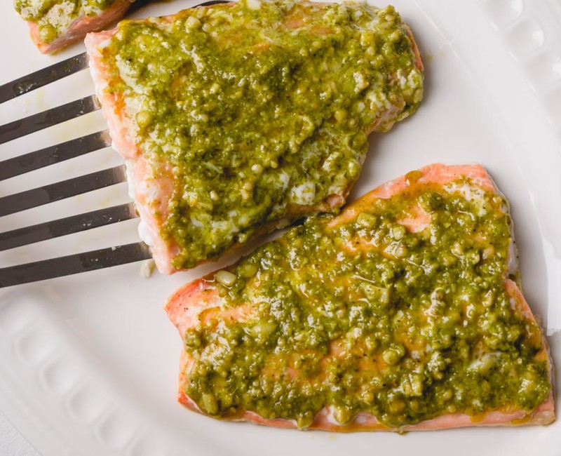 Tender soft baked salmon filet infused with herby pesto.