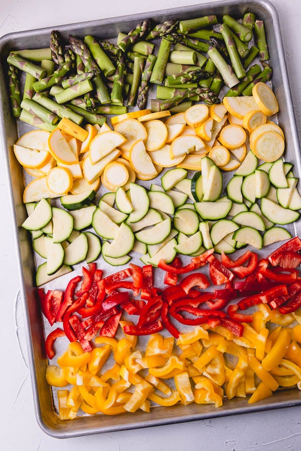 Vegetables on a baking sheet ready to be roasted. 