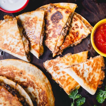 Seriously easy and delicious, these pulled pork quesadillas are my favorite way to use up leftover pulled pork! A perfect cook once, eat twice meal! #quesadillas #pulledporkquesadillas