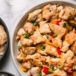 Cooked salt and pepper chicken in a larger serving platter.
