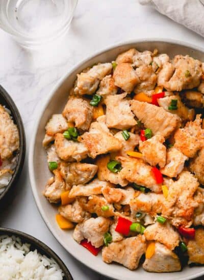 Cooked salt and pepper chicken in a larger serving platter.
