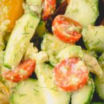 Cucumber salad with cherry tomatoes, dill and avocado.