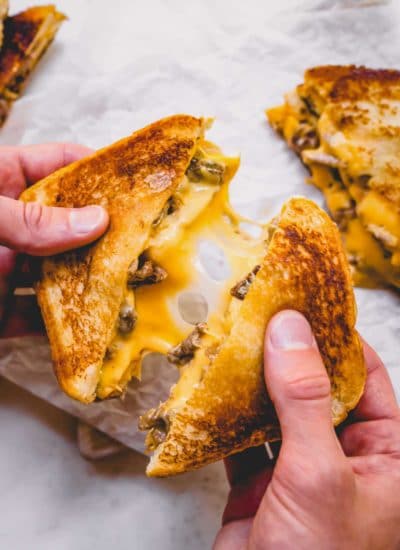 Cut grilled cheese sandwiches with oozing cheese.
