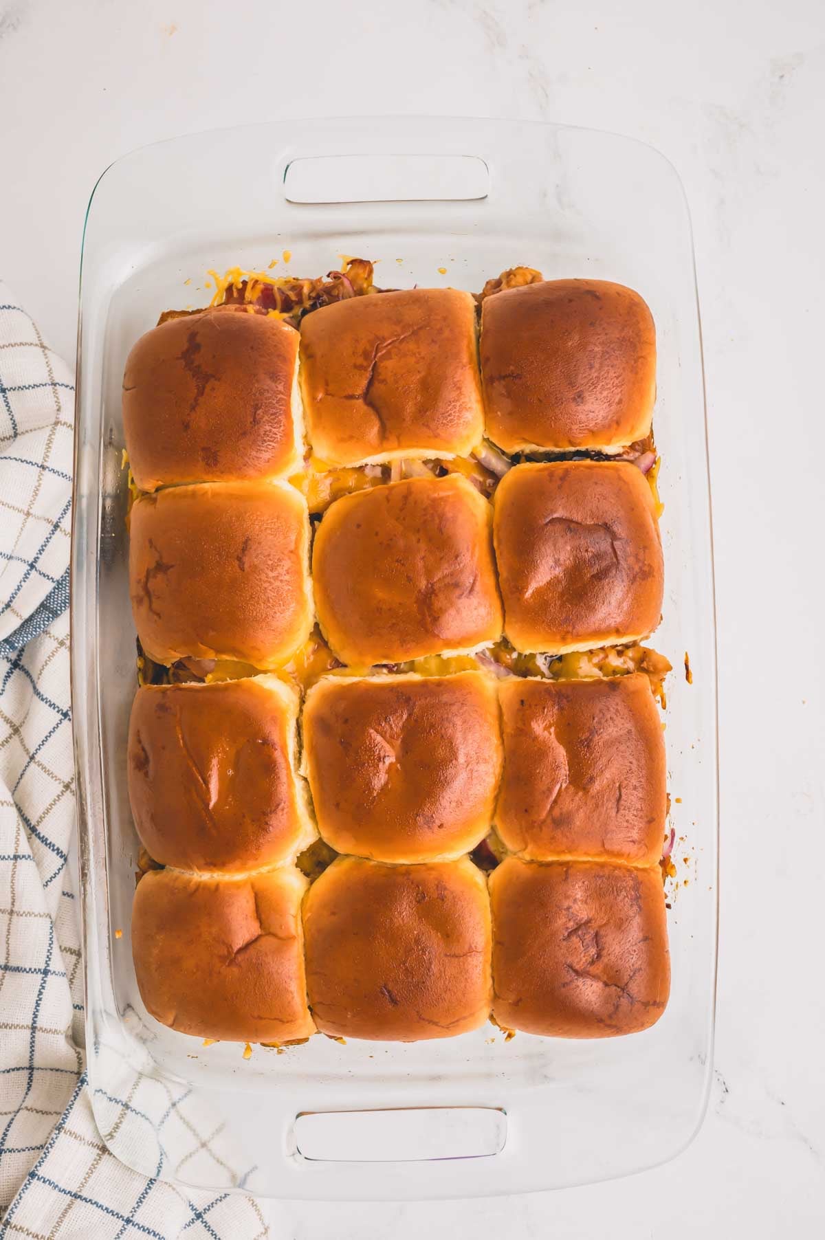 Baked sliders in a glass baking sheet.