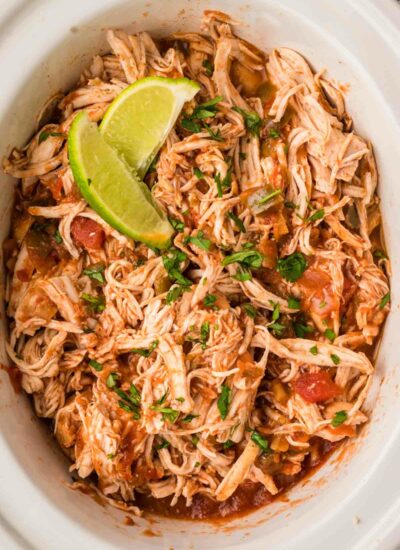 a crockpot with shredded chicken and salsa