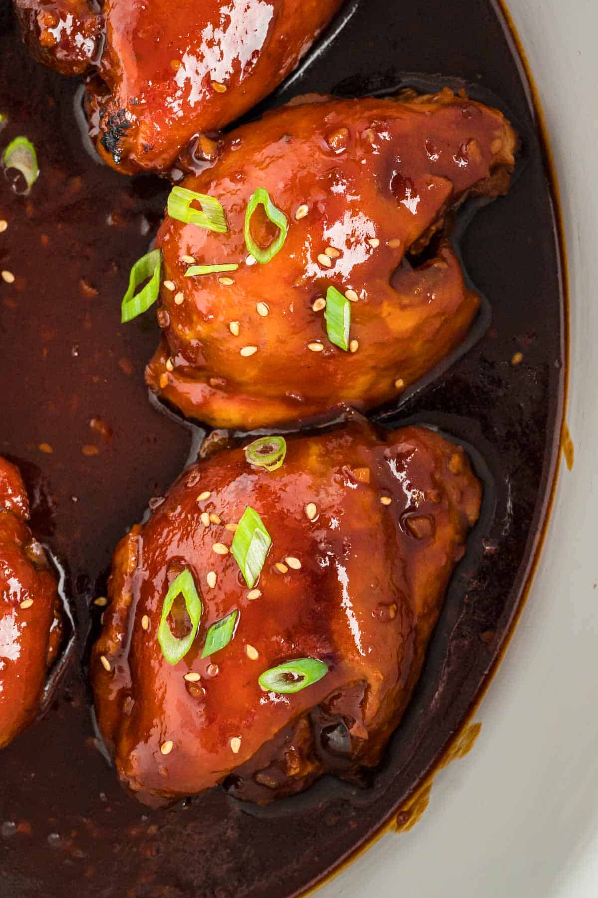 close up of honey garlic chicken with green onions.