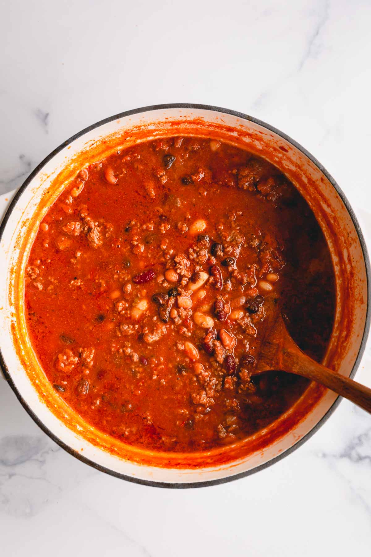 a pot of chili with a spoon in it.