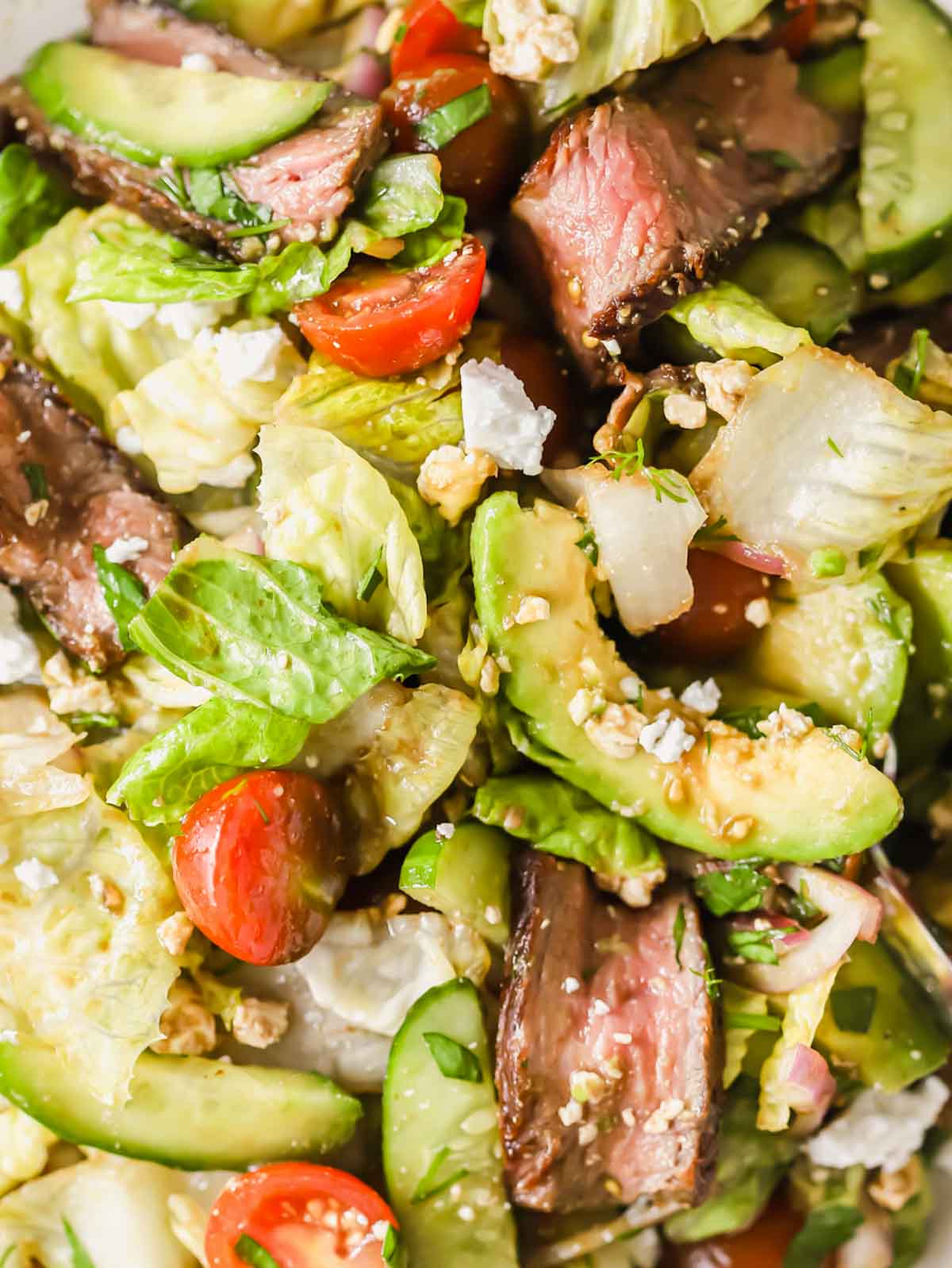 Close up image of a leftover steak salad.