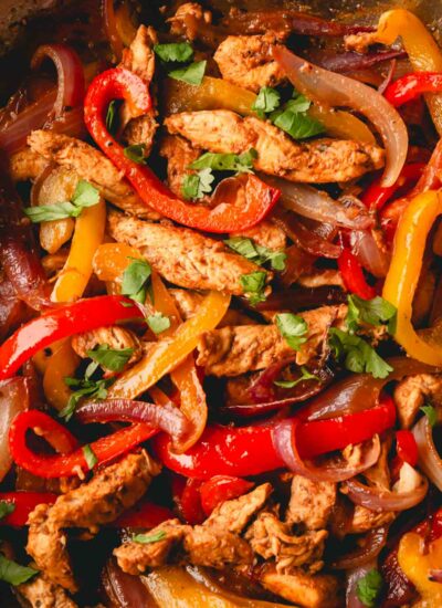 A chicken fajita mixture with chicken, onions, and peppers.