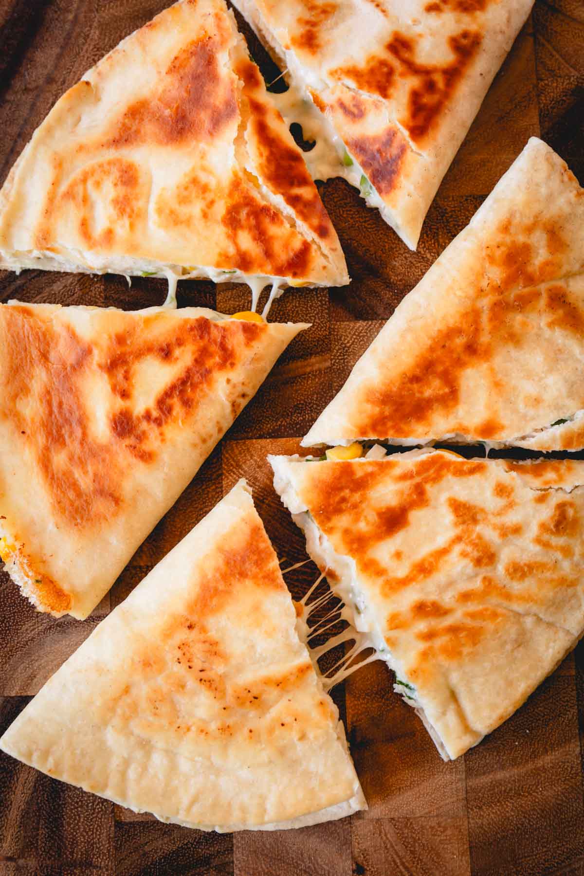Overhead image of six triangles of a chicken quesadilla.
