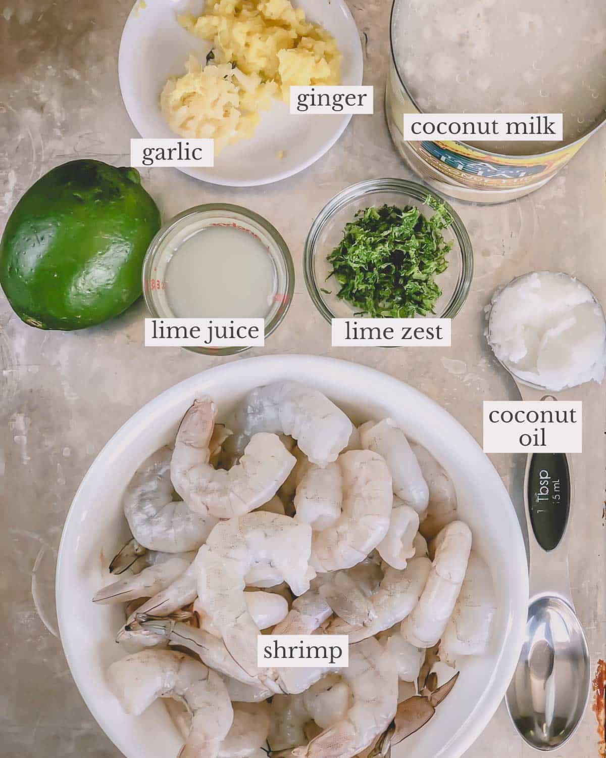 Ingredients needed to make creamy coconut shrimp with garlic, ginger, and lime.