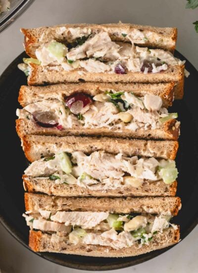Four chicken salad sandwich halves.