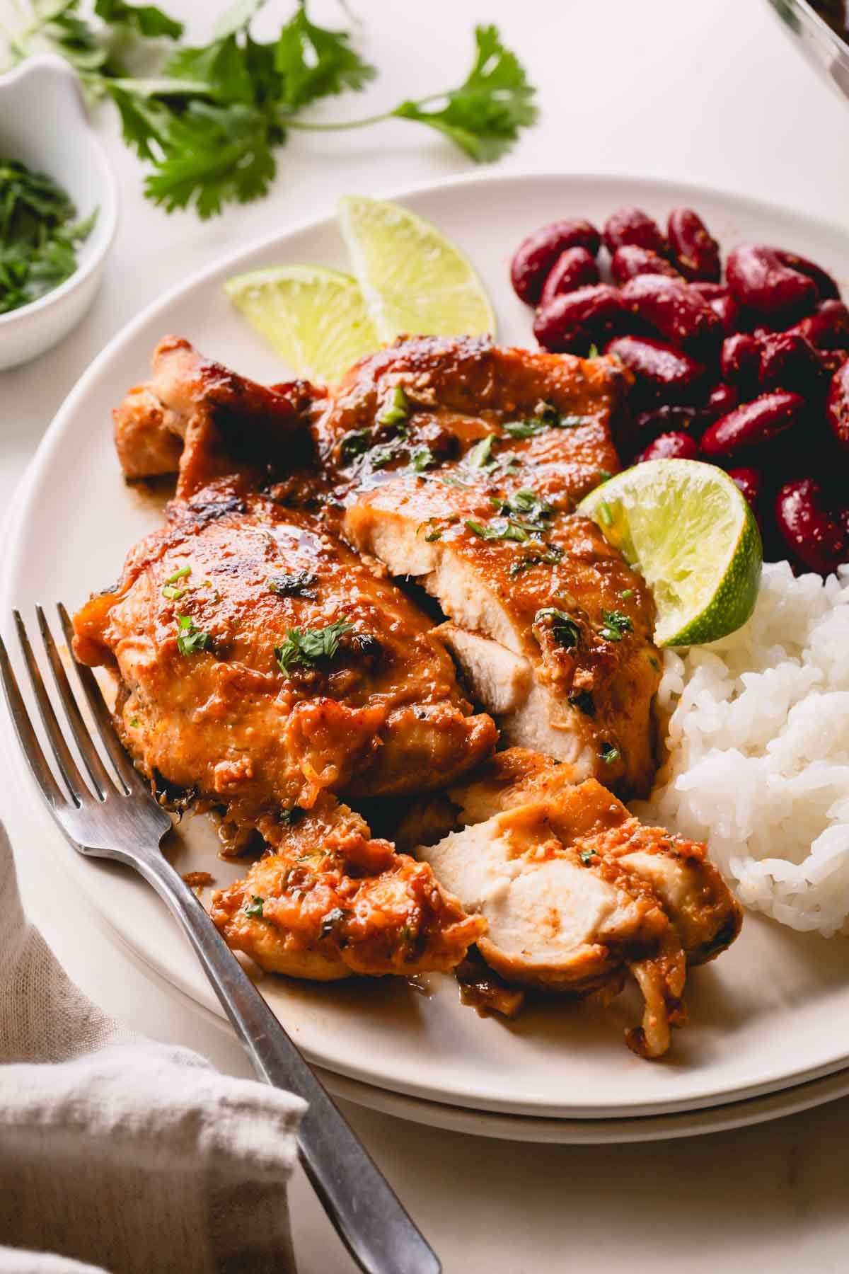 A plate of cilantro lime chicken with rice and beans.