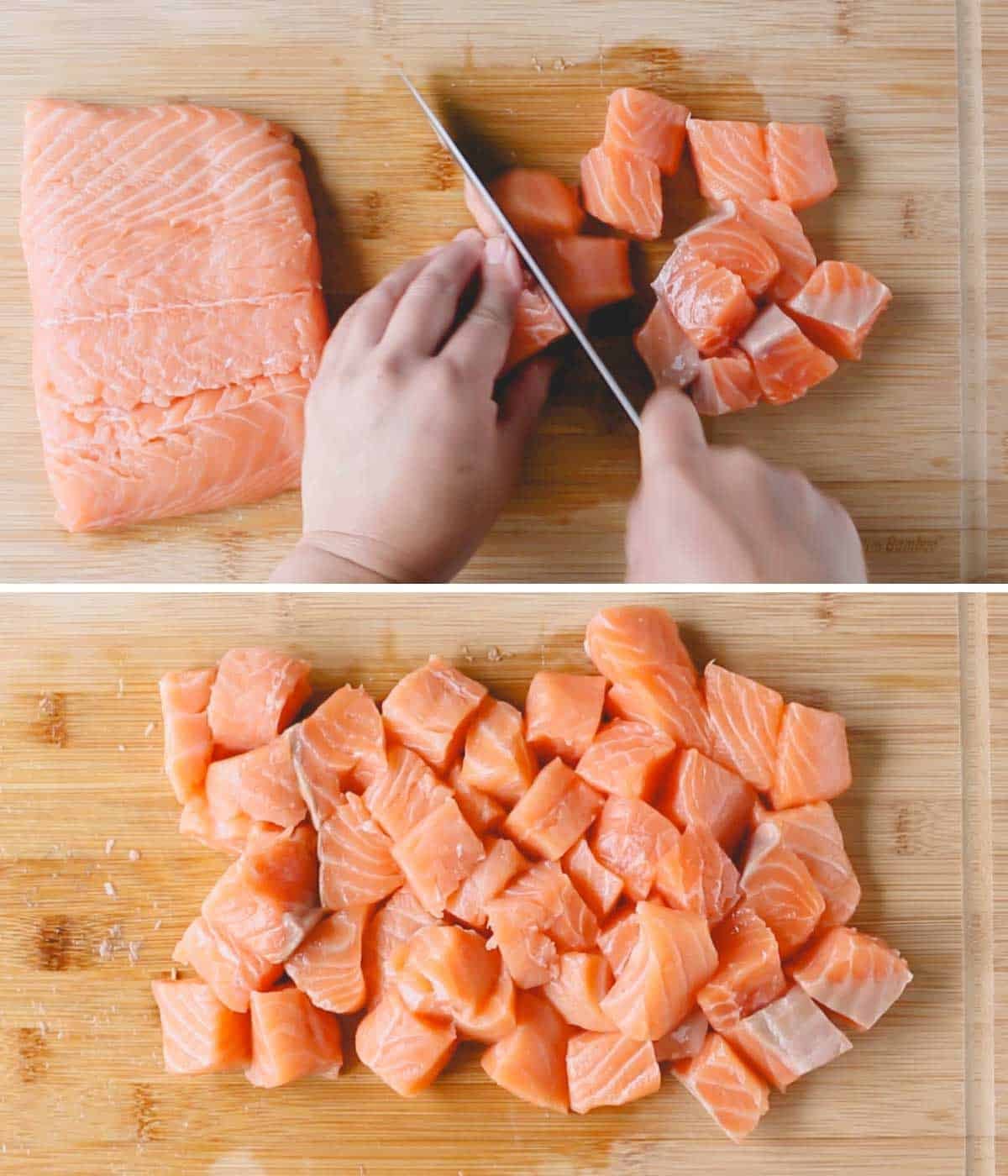 A large salmon filet being cut into cubes.