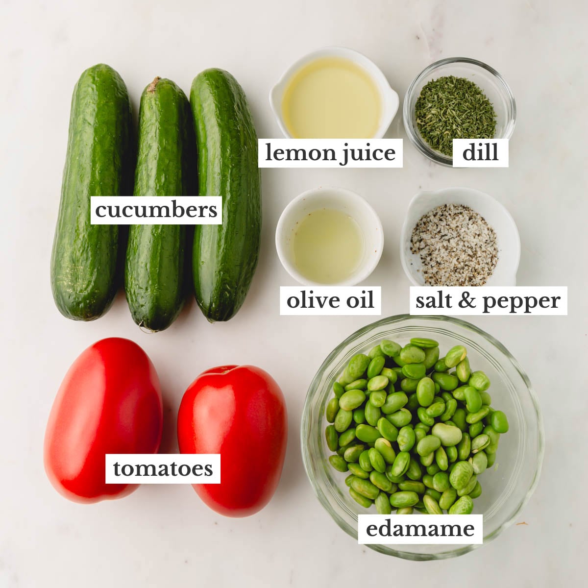 Cucumber tomato salad ingredients in individual bowls.