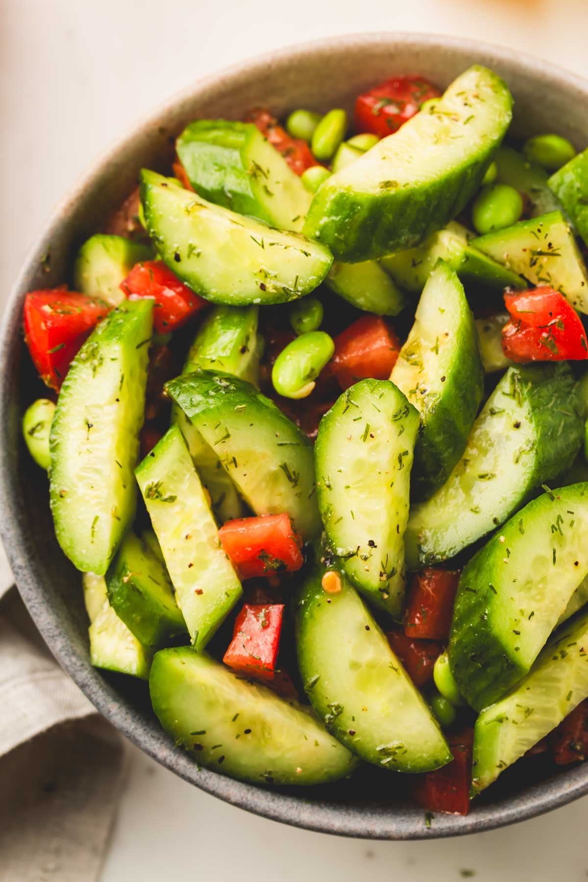 Cucumber salad in a bowl shot from the top.