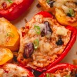 Chili, rice, and cheese stuffed peppers split in half.