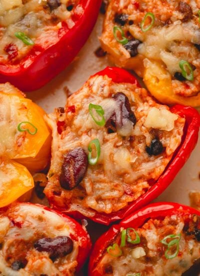 Chili, rice, and cheese stuffed peppers split in half.