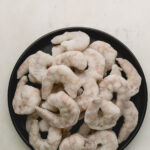 A plate of frozen shrimp.