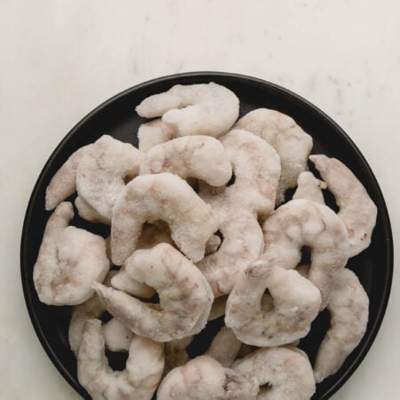 A plate of frozen shrimp.