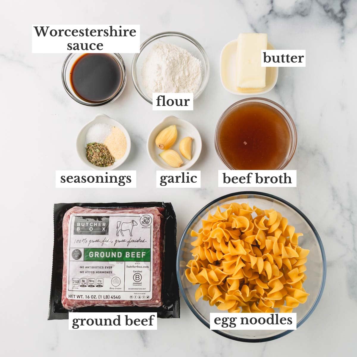 Ingredients for ground beef and noodles. They include Worcestershire sauce, flour, butter, salt, onion powder, Italian seasoning, garlic beef broth, egg noodles, and ground beef.