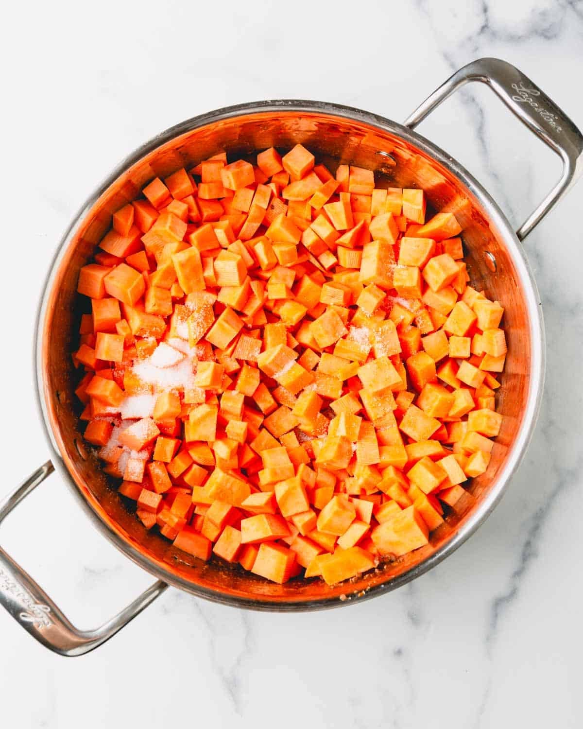 Sweet potatoes and salt are in a large skillet.