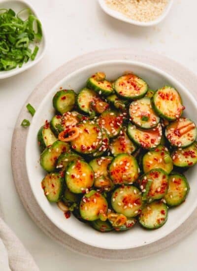 Korean cucumber salad in a white bowl.