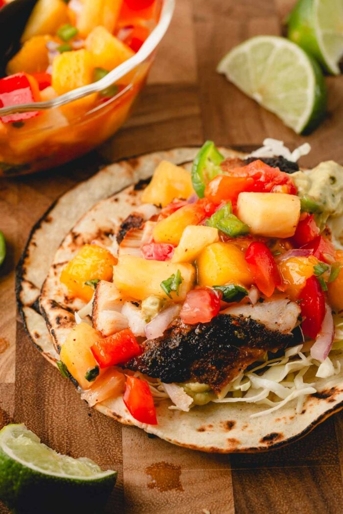 Pineapple mango salsa is served on a fish taco.