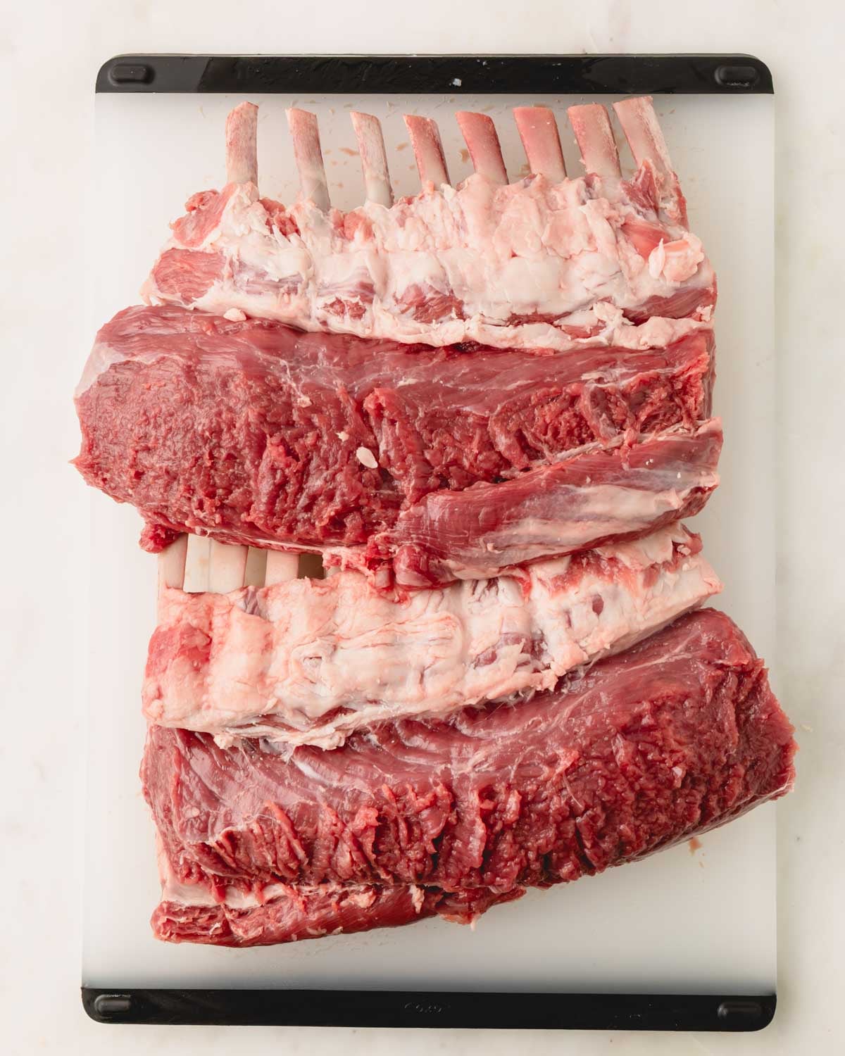 Two racks of lamb with the fat trimmed off the top.