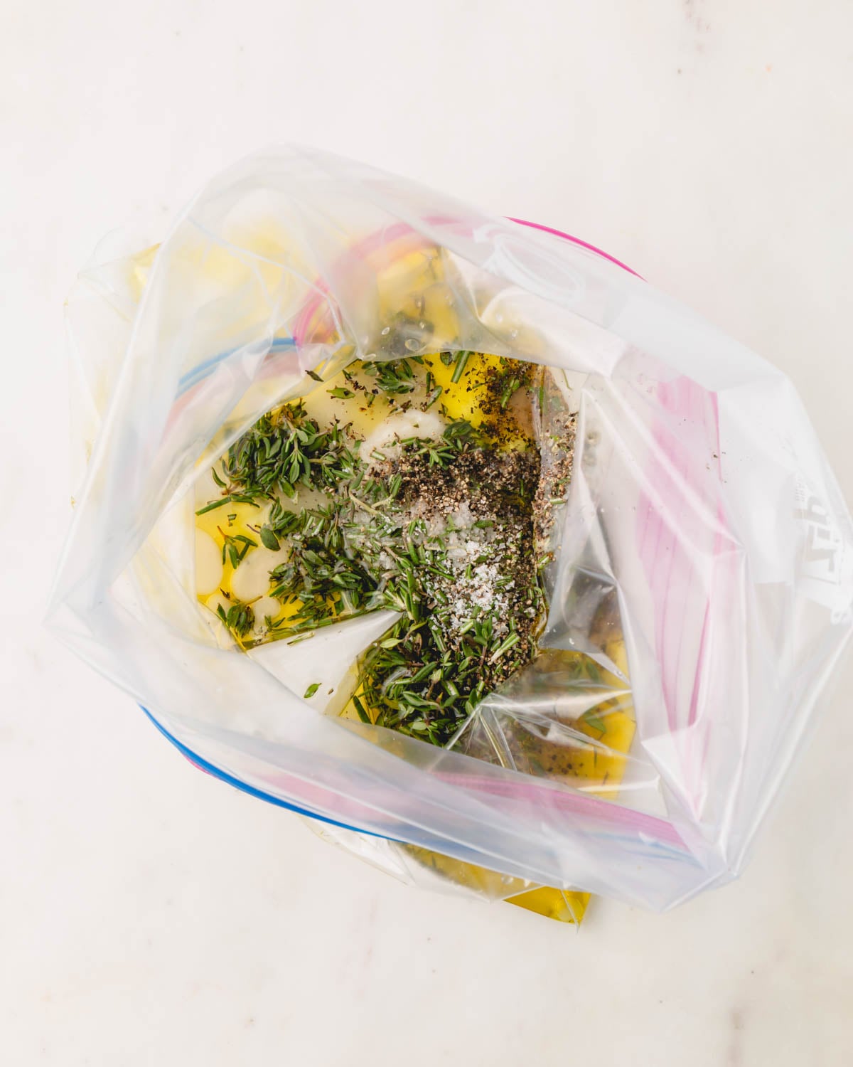 A zip top bag filled with marinade ingredients.