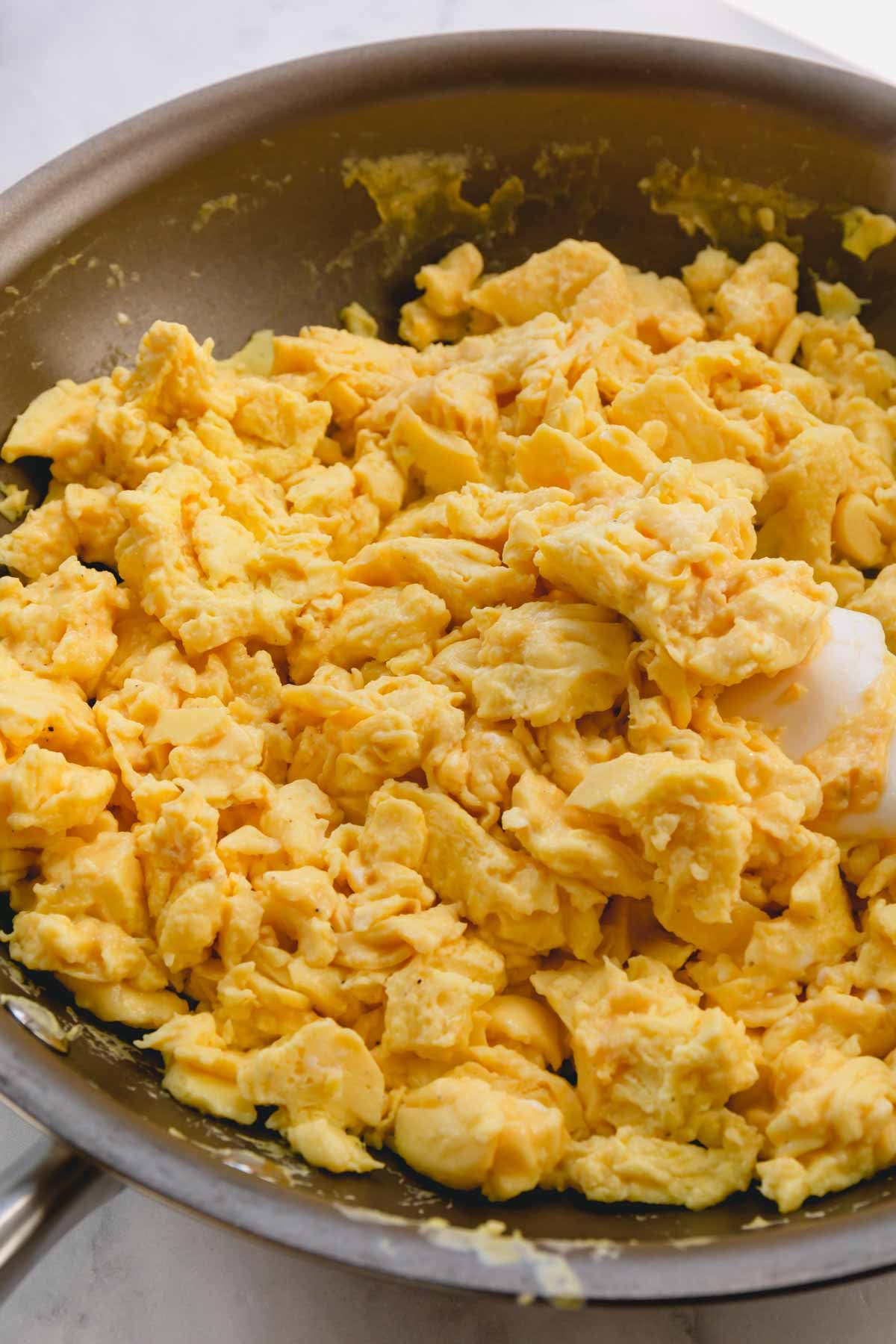 Scrambled eggs in a skillet.