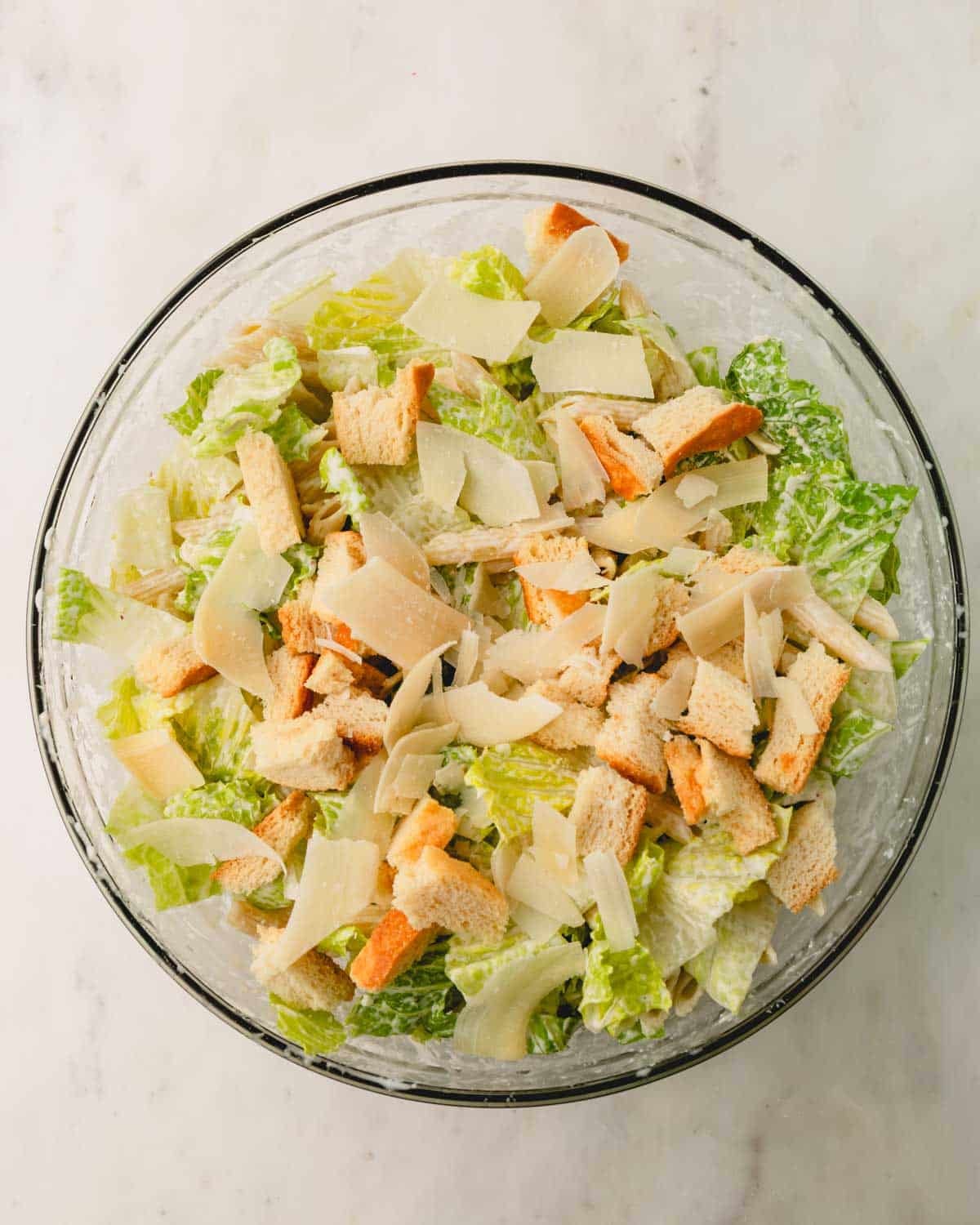 The mixed Caesar pasta salad with shaved parm and croutons added.