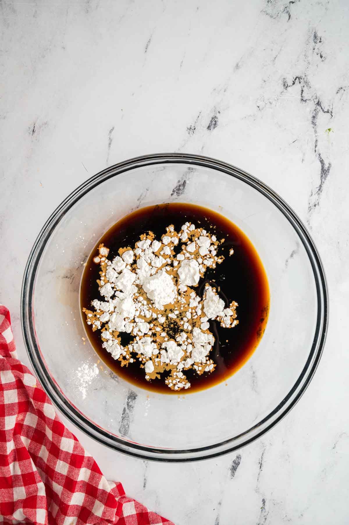 A glass bowl has the ingredients for the teriyaki marinade.